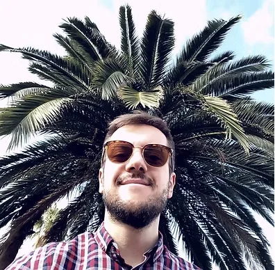Ante standing in front of palm trees