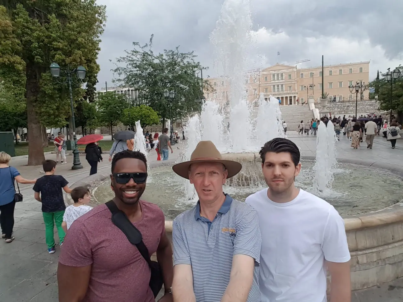 Stop Holding Back members standing near a city fountain