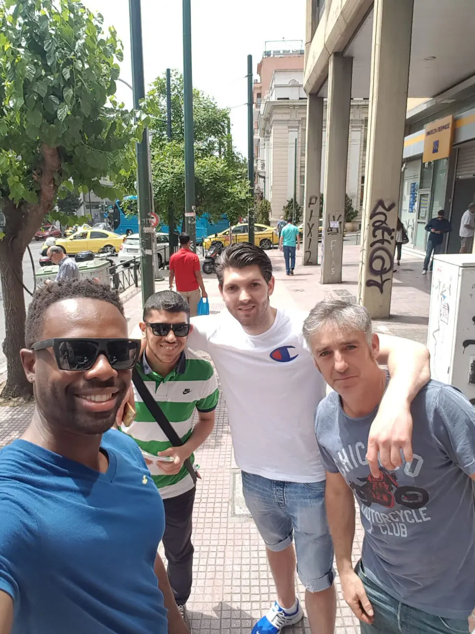 A Stop Holding Back group taking a selfie on a city street